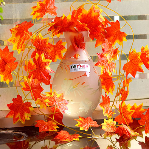 OVAL GLASS VASE WITH ARTIFICIAL MAPLE PLANT.